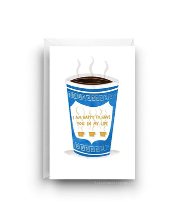 White card. Tall blue cup of coffee with steam coming out of the top. Cup has a design on it with the text 